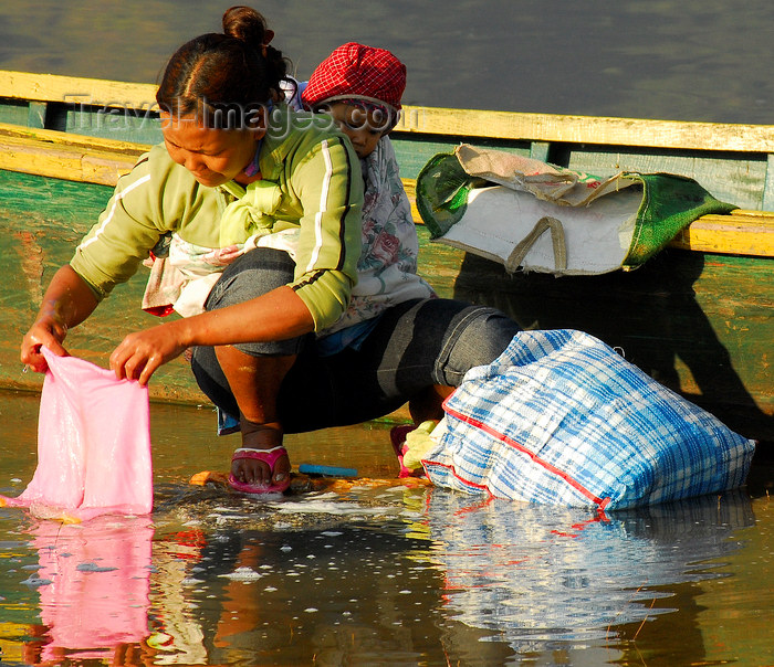 nepal163: Pokhara, Nepal: a mother washing clothes in Phewa lake with her baby on the back - photo by E.Petitalot - (c) Travel-Images.com - Stock Photography agency - Image Bank