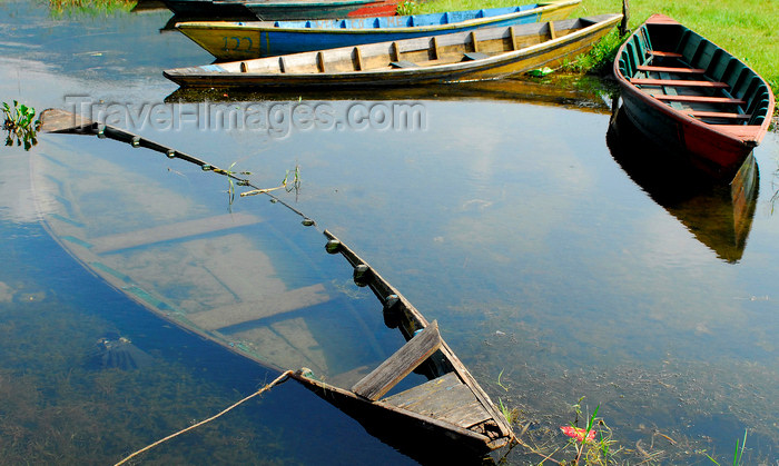nepal185: Pokhara, Nepal: half sunk small boats on Phewa lake edge - photo by E.Petitalot - (c) Travel-Images.com - Stock Photography agency - Image Bank