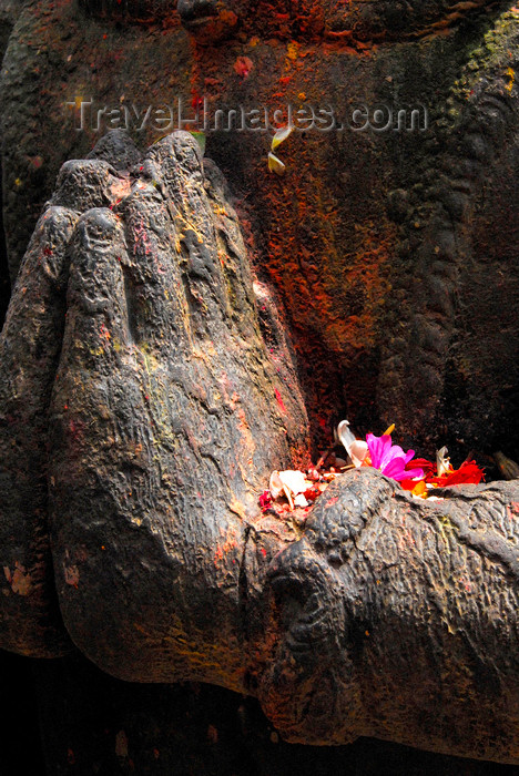 nepal196: Kathmandu, Nepal: hands of stone statue with flower offerings - photo by J.Pemberton - (c) Travel-Images.com - Stock Photography agency - Image Bank