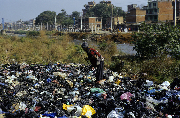 nepal254: Kathmandu, Nepal: man searches in a garbage dump along the river - photo by W.Allgöwer - (c) Travel-Images.com - Stock Photography agency - Image Bank