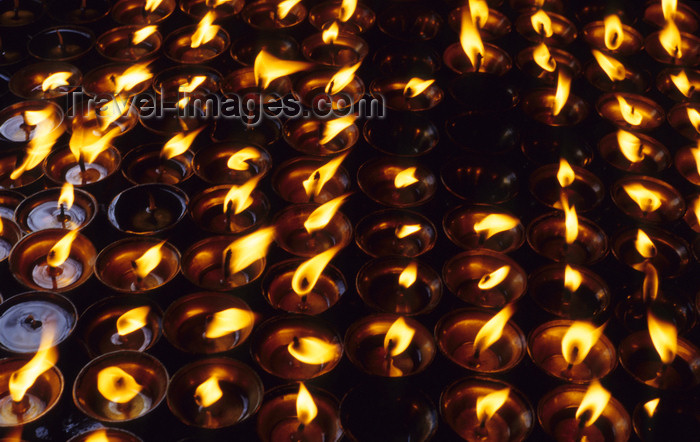 nepal255: Kathmandu, Nepal: butter lamps at a stupa - an allegory compares Buddhist reincarnation with the flame of a candle, as time passes neither the candle itself, nor the flame, are the same, but without the first candle there would be no flame - photo by W.Allgöwer - (c) Travel-Images.com - Stock Photography agency - Image Bank