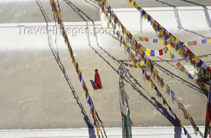 nepal283: Kathmandu valley, Nepal: Bodhnath temple complex - Buddhist novice and prayer flags - photo by W.Allgöwer - (c) Travel-Images.com - Stock Photography agency - Image Bank