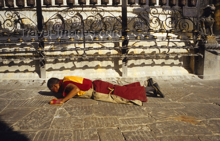 nepal286: Kathmandu valley, Nepal: Swayambhunath religious complex - monk in prostration - showing reverence to the Triple Gem - among the meritorious deeds in Buddhism - photo by W.Allgöwer - (c) Travel-Images.com - Stock Photography agency - Image Bank