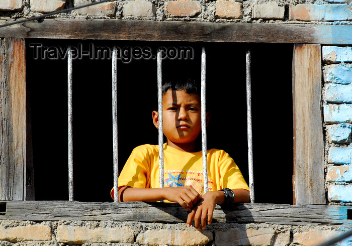 nepal3: Kathmandu, Nepal: a boy behind bars looks outside - photo by E.Petitalot - (c) Travel-Images.com - Stock Photography agency - Image Bank