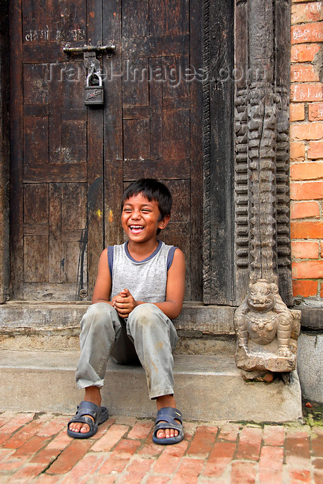 nepal301: Patan, Lalitpur District, Bagmati Zone, Nepal: local boy sitting in carved doorway - photo by J.Pemberton - (c) Travel-Images.com - Stock Photography agency - Image Bank