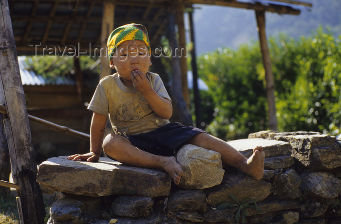 nepal334: Annapurna area, Nepal: child on a stone wall - photo by W.Allgöwer - (c) Travel-Images.com - Stock Photography agency - Image Bank