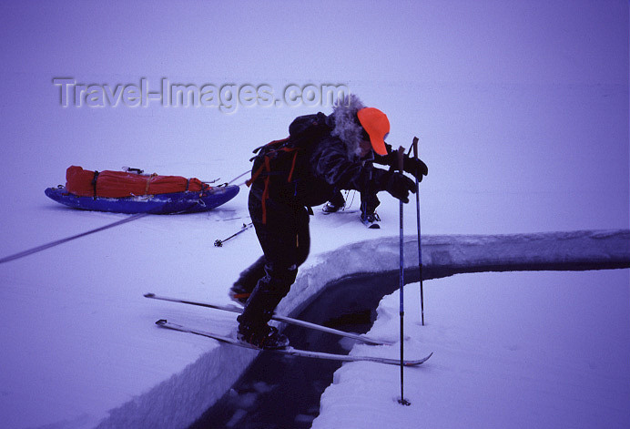 north-pole7: Arctic Ocean: Mark George negotiates a narrow crack - Arctic adventure - skiing - North Pole Expedition (photo by Eric Philips) - (c) Travel-Images.com - Stock Photography agency - Image Bank