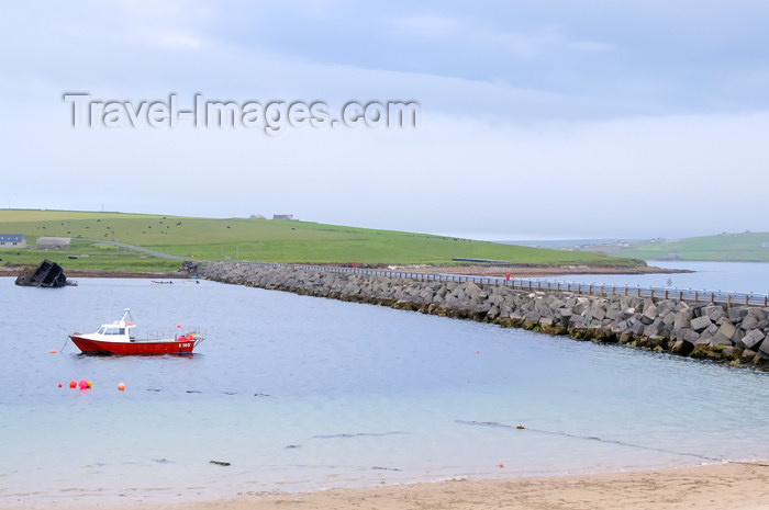 orkney55: Orkney island, Mainland - View of the Churchill Battiers with a fishing vessel at anchor and a ship wreck in the background. - (c) Travel-Images.com - Stock Photography agency - the Global Image Bank