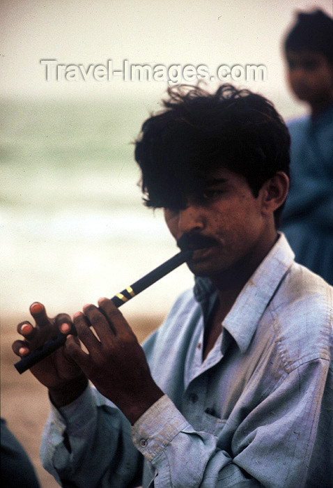 pakistan60: Karachi, Sindh, Pakistan: musical evening - man playing the flute on the beach - photo by R.Zafar - (c) Travel-Images.com - Stock Photography agency - Image Bank