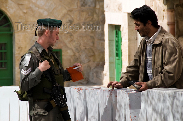 palest25: Hebron, West Bank, Palestine: Israeli soldier checking Palestinian ID at checkpoint - photo by J.Pemberton - (c) Travel-Images.com - Stock Photography agency - Image Bank