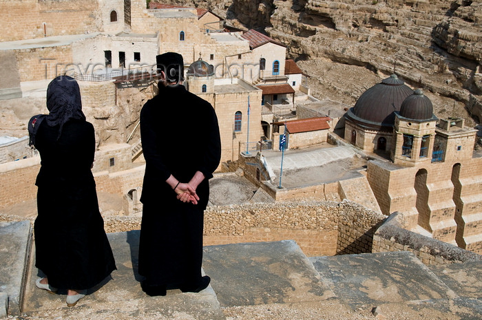 palest40: Mar Saba Monastery, West Bank, Palestine:  Greek Orthodox monk and female visitor overlooking the monastery - Great Lavra of St. Sabas - photo by J.Pemberton - (c) Travel-Images.com - Stock Photography agency - Image Bank