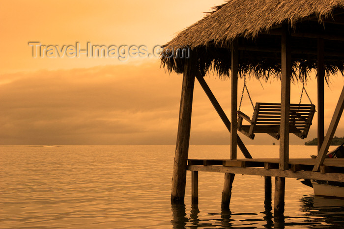 panama170: Panama - Bocas del Toro - Palm roofed dock - hanging bench - photo by H.Olarte - (c) Travel-Images.com - Stock Photography agency - Image Bank