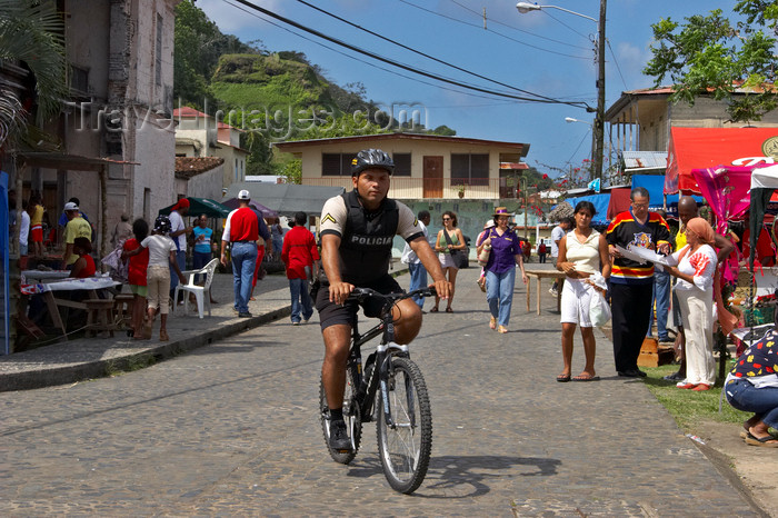 panama286: A bike-mounted policeman patrols the street near the Portobello Customs House during the devil and congo festival - photo by H.Olarte - (c) Travel-Images.com - Stock Photography agency - Image Bank