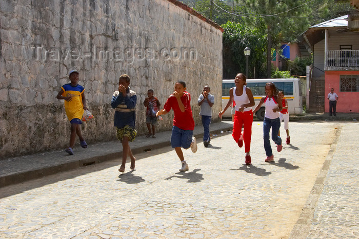 panama290: A group of african american kids run on a cobblestone side street, participating on a spoon and egg race. Portobello, Colon, Panama, Central America - photo by H.Olarte - (c) Travel-Images.com - Stock Photography agency - Image Bank