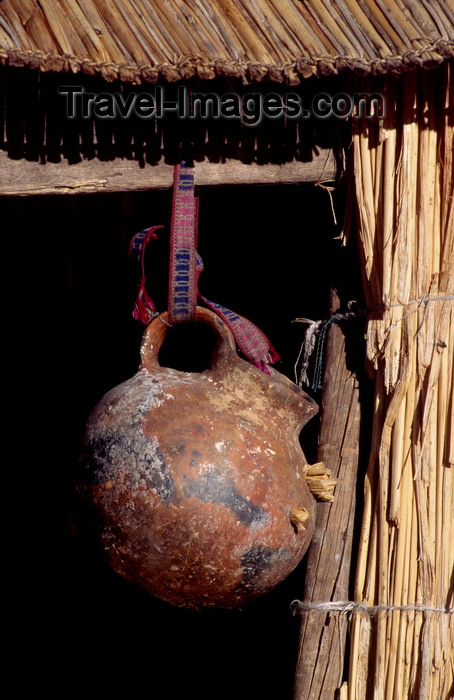 peru108: Lake Titicaca, Puno department, Peru: water vessel hangs from a reed house on the floating islands - photo by C.Lovell - (c) Travel-Images.com - Stock Photography agency - Image Bank