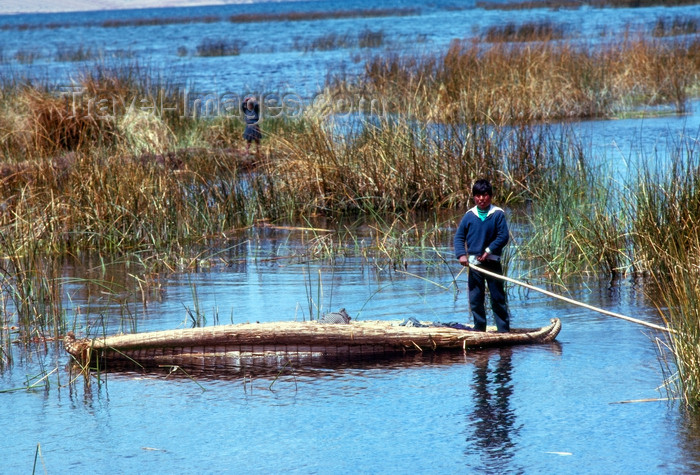 peru44: Lake Titicaca - Puno region, Peru: Uro boy on a totora reeds canoe - photo by J.Fekete - (c) Travel-Images.com - Stock Photography agency - Image Bank