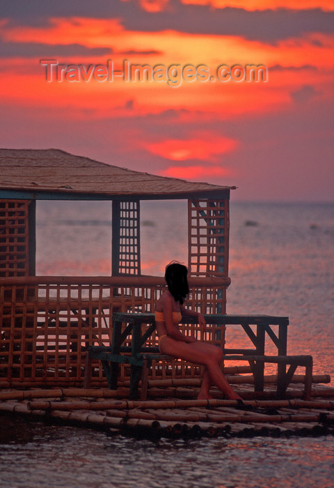 phil15: Philippines - Beach - sunset - girl relaxing - benches -  photo by B.Henry - (c) Travel-Images.com - Stock Photography agency - Image Bank