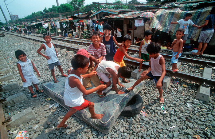 phil20: Manila city, Philippines - children play with an old matress - Slums and shanty towns - photo by B.Henry - (c) Travel-Images.com - Stock Photography agency - Image Bank