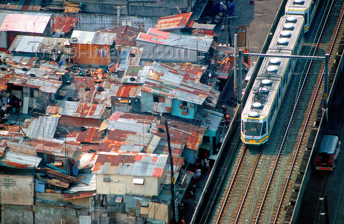 phil33: Metro Manila, Philippines - Elevated Light Rail Track LRT and slum - photo by B.Henry - (c) Travel-Images.com - Stock Photography agency - Image Bank