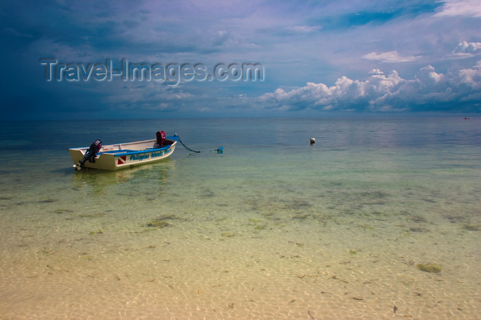 phil48: Alona Beach, Bohol island, Central Visayas, Philippines: lone boat moored by the beach with storm clouds in the background - photo by S.Egeberg - (c) Travel-Images.com - Stock Photography agency - Image Bank