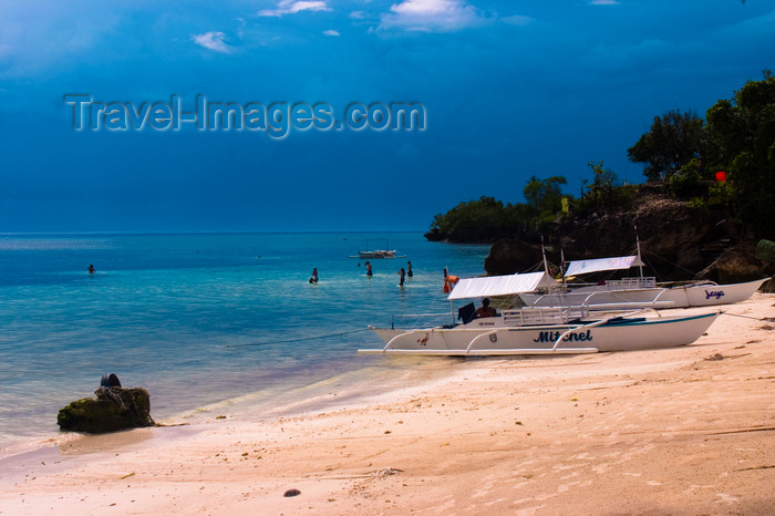 phil53: Alona Beach, Bohol island, Central Visayas, Philippines: bancas and toursits on the beach - storm clouds - photo by S.Egeberg - (c) Travel-Images.com - Stock Photography agency - Image Bank