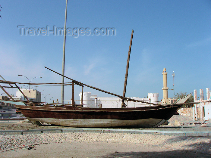 qatar13: Doha, Qatar: fishing dhow on land  - Al-Khoot Fort in the background - Dhow Round About - photo by B.Cloutier - (c) Travel-Images.com - Stock Photography agency - Image Bank