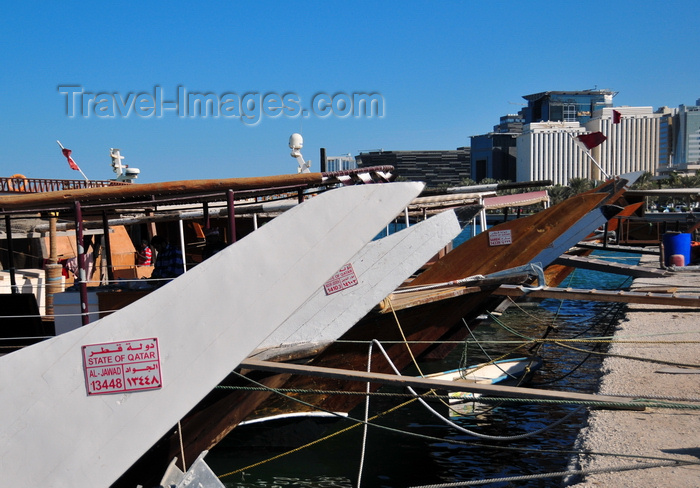 qatar40: Doha, Qatar: dhow prows with State of Qatar registration - Dhow harbour - south end of the Corniche in the background, Regency Business Center - photo by M.Torres - (c) Travel-Images.com - Stock Photography agency - Image Bank