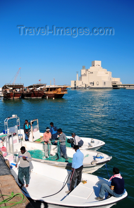 qatar45: Doha, Qatar: fishermen in the Dhow Harbour with the Museum of Islamic Art as backdrop - photo by M.Torres - (c) Travel-Images.com - Stock Photography agency - Image Bank