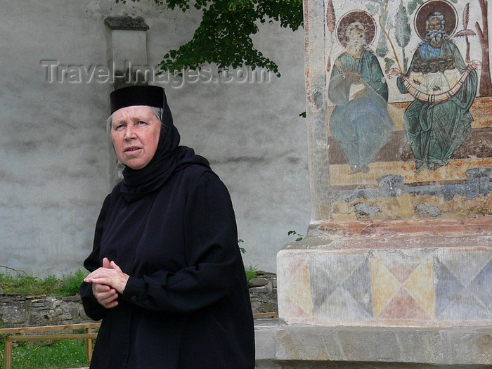 romania78: Gura Humorului, Suceava county, southern Bukovina, Romania: nun and frescoes - Voronet Monastery - photo by J.Kaman - (c) Travel-Images.com - Stock Photography agency - Image Bank