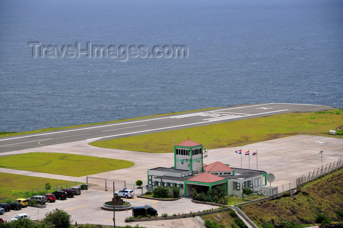 saba62: Flat Point, Saba: Juancho E. Yrausquin Airport by the sea - terminal building, heliport and the very short runway - IATA SAB, ICAO TNCS - the shortest airstrip in the world, a large white X indicates that it is not for commercial flights - photo by M.Torres - (c) Travel-Images.com - Stock Photography agency - Image Bank