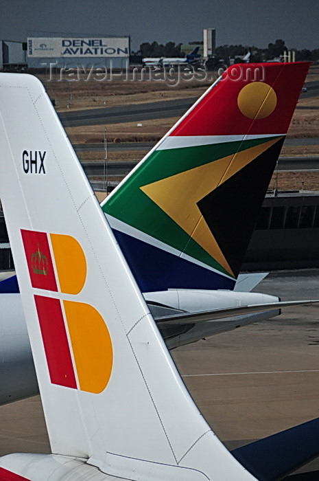 safrica247: Johannesburg, Gauteng, South Africa: A340 and A330 aircraft tails - Iberia and South African Airways - Iberia Airbus A340-313, EC-GHX 'Rosalia de Castro' and South African Airways Airbus A330-243 ZS-SXX - OR Tambo International / Johannesburg International Airport / Jan Smuts / JNB - Kempton Park, Ekurhuleni - photo by M.Torres - (c) Travel-Images.com - Stock Photography agency - Image Bank