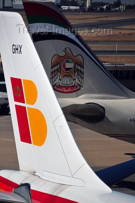 safrica249: Johannesburg, Gauteng, South Africa: Airbus A340 and A330 aircraft tails - Iberia and Etihad - Iberia Airbus A340-313, EC-GHX 'Rosalia de Castro' and Etihad Airways Airbus A330-243 A6-EYJ - OR Tambo International / Johannesburg International Airport / Jan Smuts / JNB - Kempton Park, Ekurhuleni - photo by M.Torres - (c) Travel-Images.com - Stock Photography agency - Image Bank