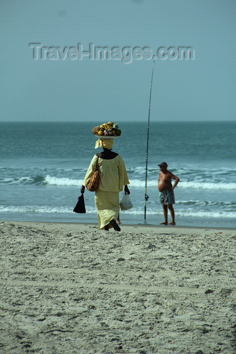 senegal108: Cap Skirring, Oussouye, Basse Casamance (Ziguinchor), Senegal: Woman Walking on the beach to sell fruits and a man fishing, everyday life / Mulher caminhando na praia para vender frutas e homem a pescar, vida quotidiana - photo by R.V.Lopes - (c) Travel-Images.com - Stock Photography agency - Image Bank