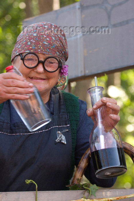 slovenia126: Slovenia - Lipica / Lipizza - Goriska region: Lipica stud farm - Craft fair during an special open day - woman putting on a winemaking show - photo by I.Middleton - (c) Travel-Images.com - Stock Photography agency - Image Bank