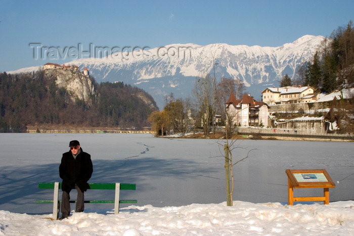 slovenia179: Slovenia - men on bench - view across Lake Bled in Slovenia when frozen over in winter - Karavanke mountain range - photo by I.Middleton - (c) Travel-Images.com - Stock Photography agency - Image Bank