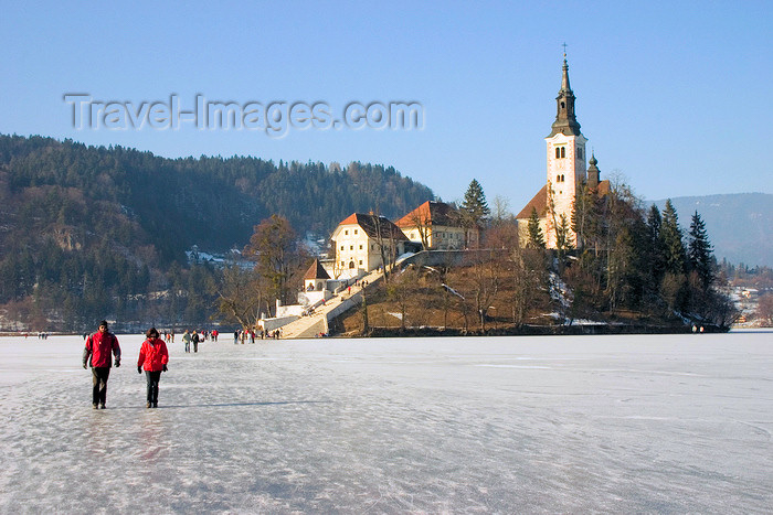 slovenia181: Slovenia - people walking across ice - island church on Lake Bled in Slovenia when frozen over in winter - photo by I.Middleton - (c) Travel-Images.com - Stock Photography agency - Image Bank