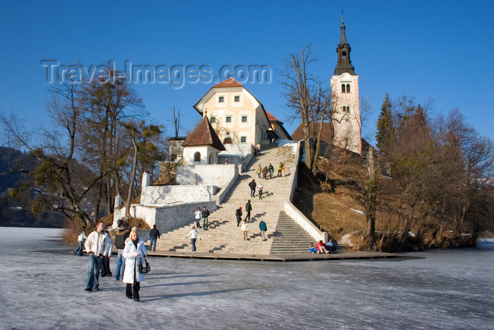 slovenia182: Slovenia - View across to the island church on Lake Bled in Slovenia when frozen over in winter with people walking across ice - photo by I.Middleton - (c) Travel-Images.com - Stock Photography agency - Image Bank