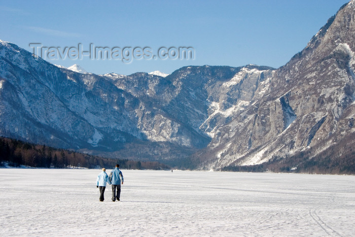 slovenia225: Slovenia - Couple walking across Bohinj Lake / Wocheinersee when frozen over - view towards Ukanc - photo by I.Middleton - (c) Travel-Images.com - Stock Photography agency - Image Bank