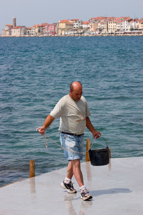 slovenia295: Slovenia - Piran: getting a bucket of sea water - photo by I.Middleton - (c) Travel-Images.com - Stock Photography agency - Image Bank