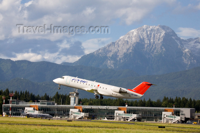slovenia622: Slovenia - Brnik Airport: Adria Airways Canadair Regional Jet CRJ200LR S5-AAD airplane taking off from Ljubljana Joze Pucnik Airport - terminal T1 and mountains - photo by I.Middleton - (c) Travel-Images.com - Stock Photography agency - Image Bank