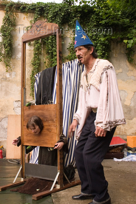 slovenia669: Slovenia - Kamnik Medieval Festival: magician preparing to chop off girl's head - photo by I.Middleton - (c) Travel-Images.com - Stock Photography agency - Image Bank