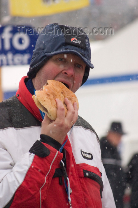 slovenia689: Hungry man eating large hamburger at Planica ski jumping championships, Slovenia - photo by I.Middleton - (c) Travel-Images.com - Stock Photography agency - Image Bank