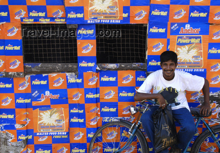 sri-lanka127: Sri Lanka - near Weligama: Youth with bicycle against billboard (photo by B.Cain) - (c) Travel-Images.com - Stock Photography agency - Image Bank