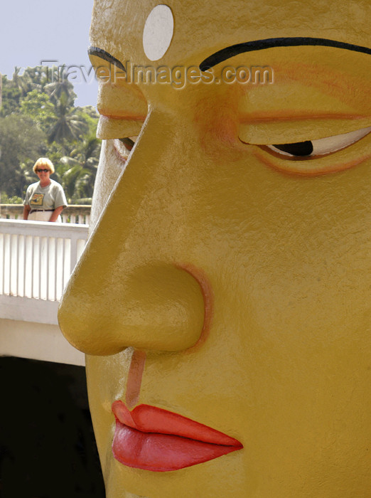 sri-lanka54: Matara, Southern province, Sri Lanka: temple - Buddha face close-up with tourist - photo by B.Cain - (c) Travel-Images.com - Stock Photography agency - Image Bank