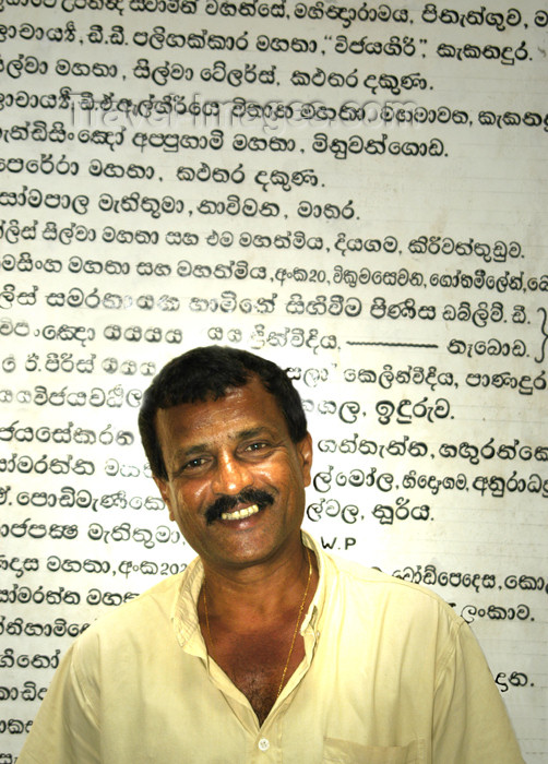 sri-lanka71: Matara, Southern province, Sri Lanka: temple - guide with Sinhalese text in the background - photo by B.Cain - (c) Travel-Images.com - Stock Photography agency - Image Bank