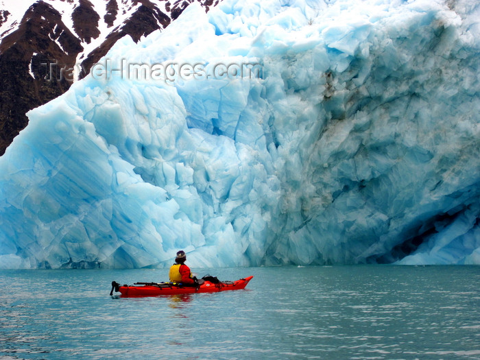 svalbard2: Svalbard - Spitsbergen island: kayaking guide, Judd Hill, observes an enormous iceberg carved from the 14 July galcier - photo by R.Eime - (c) Travel-Images.com - Stock Photography agency - Image Bank