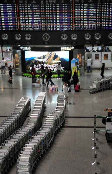 taiwan44: Taipei, Taiwan: baggage carts and departures board at Terminal 2 of Taiwan Taoyuan International Airport - located west of Taipei in Dayuan District, Taoyuan - photo by M.Torres - (c) Travel-Images.com - Stock Photography agency - Image Bank