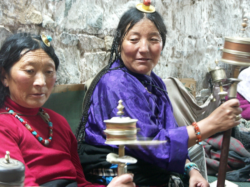 tibet27: Tibet - Lhasa: Tibetan women in colourful dress spinning prayer wheels - photo by P.Artus - (c) Travel-Images.com - Stock Photography agency - Image Bank