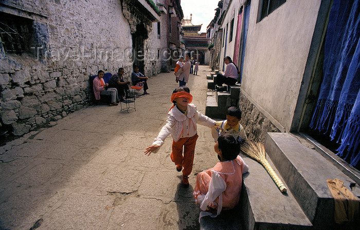 tibet87: Lhasa, Tibet: street life behind Jokhang Monastery - children playing - photo by Y.Xu - (c) Travel-Images.com - Stock Photography agency - Image Bank