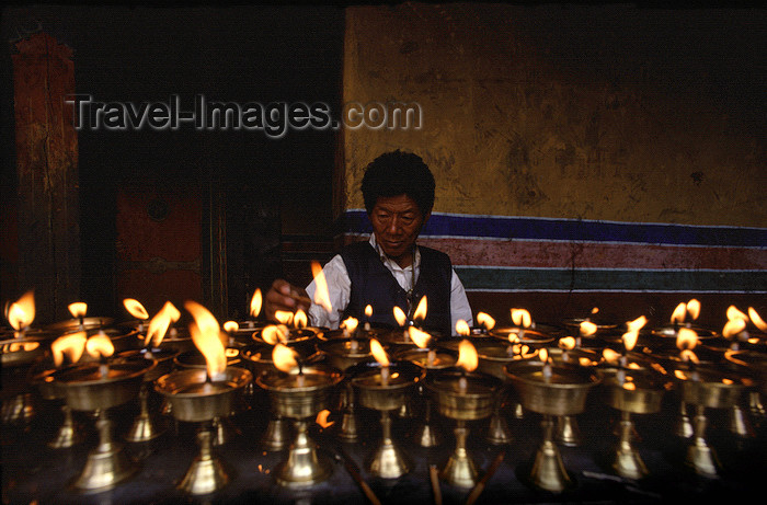 tibet95: Tibet - lighting butter lamps - photo by Y.Xu - (c) Travel-Images.com - Stock Photography agency - Image Bank